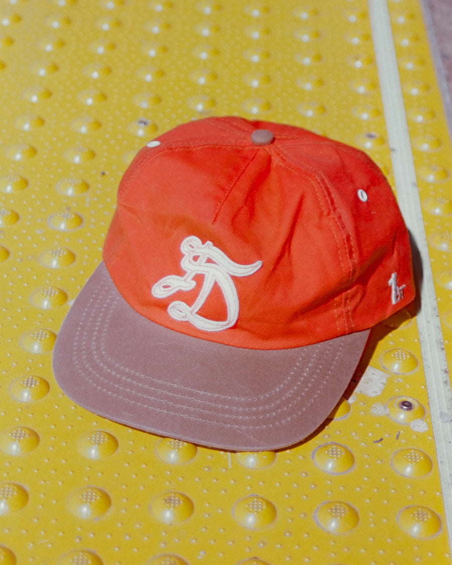 First Draft C001_HAT_05 orange waxed cotton hat with caramel brim